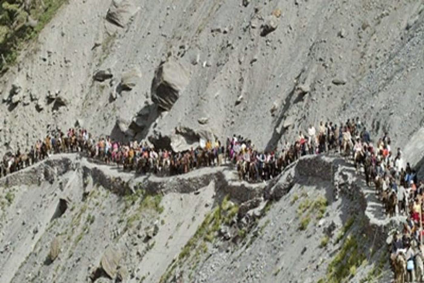 Pilgrims walking the high mountain trail of the Amarnath Yatra